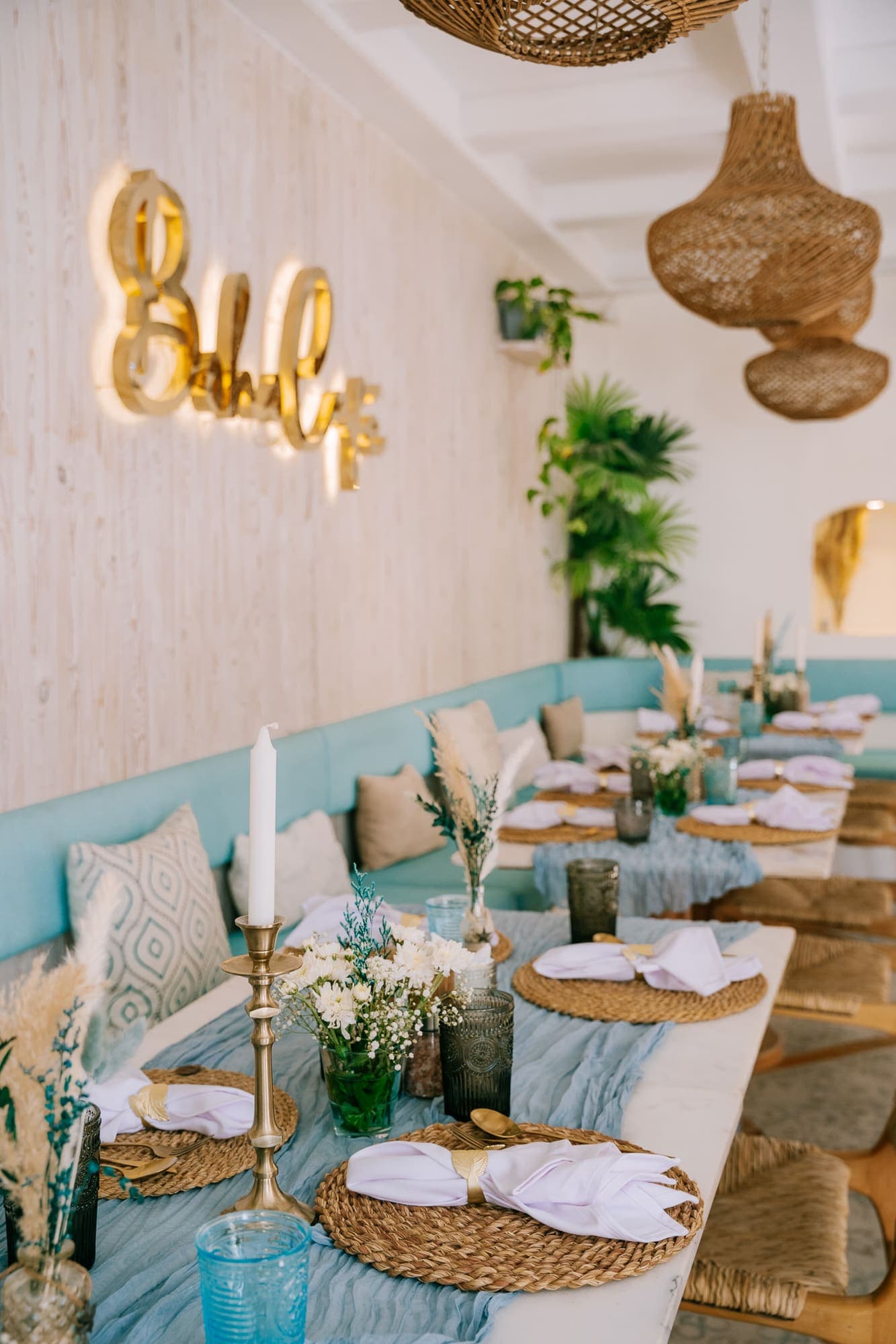 The gold Boho Café sign above a cushioned banquette